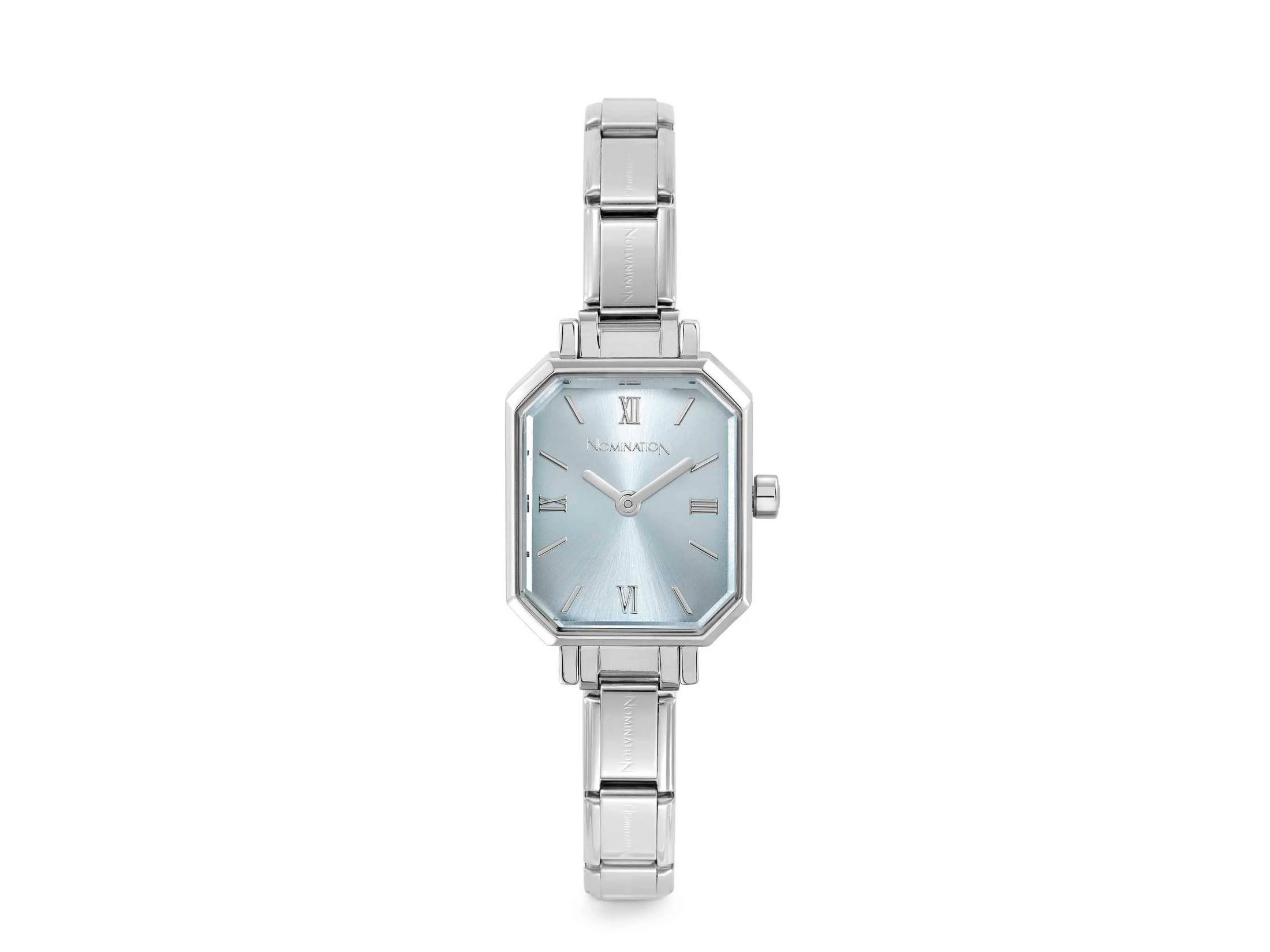 Hellblaue Nomination Uhr 076037 15 mit elegantem, achteckigem Gehäuse und silbernem Armband. Modernes Design mit römischen Ziffern als Zeitangabe. Ideal für stilbewusste Träger.